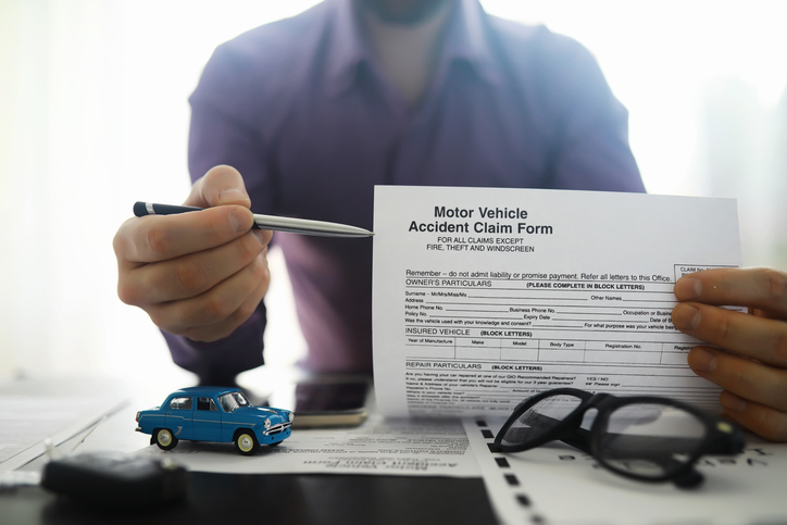 The insurance agent signs a document. Car insurance policy. Auto insurance policy. Forms registration of the contract.